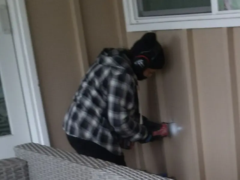 Professional electrician installing an exterior outlet in Hominy